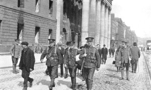 Three Fusiliers pass the burnt out General Post Office - Dublin 1916