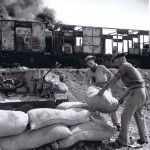 Inniskillings unloading bags of rice from a burning train