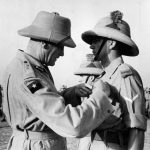 Fusilier Newman receiving his MM from General Auchinleck